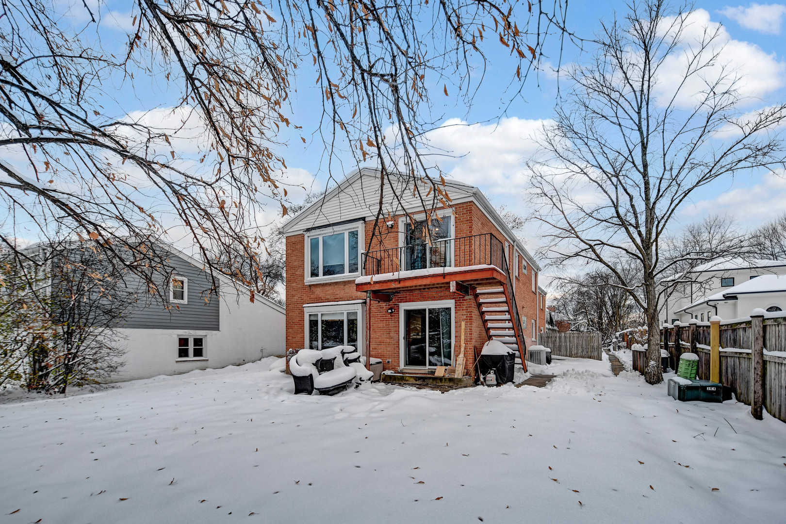 491 Old Surrey Road, Unit A Hinsdale, IL 60521 - Photo 21 of 23 a view of a house with a yard covered in snow