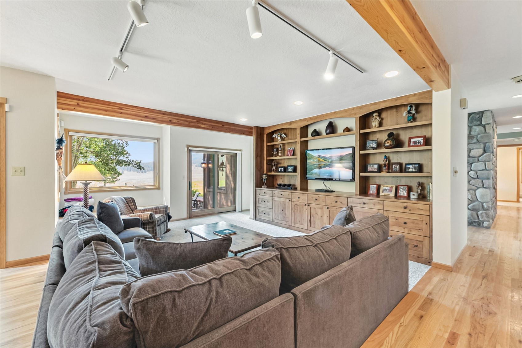 The family room has beautiful built-in shelving and has access to the spacious patio overlooking the golf course.