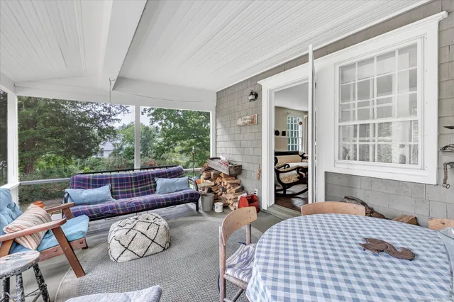 a bedroom with furniture and a large window