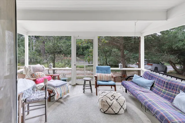 a living room with furniture and a floor to ceiling window