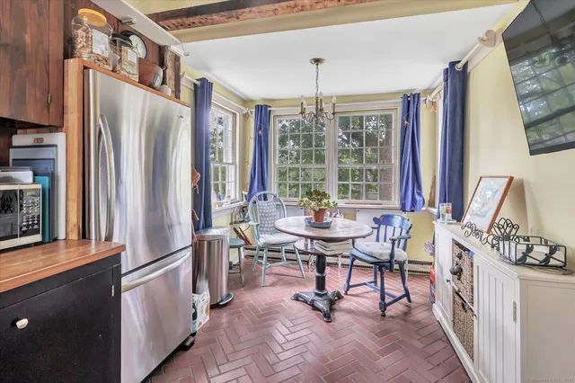 a view of a dining room with furniture and windows