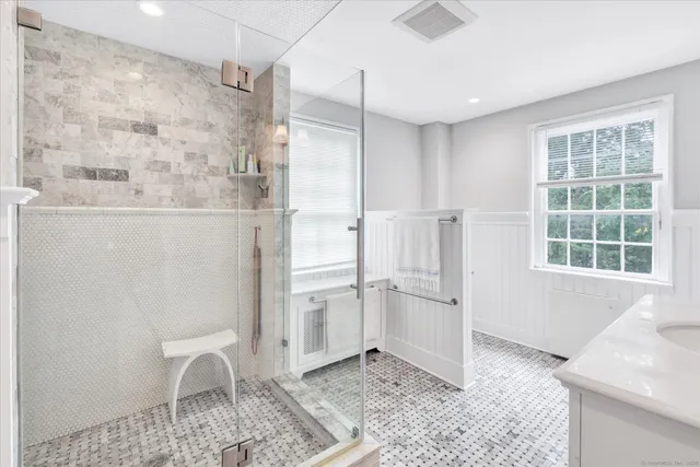 a bathroom with a sink a mirror and shower