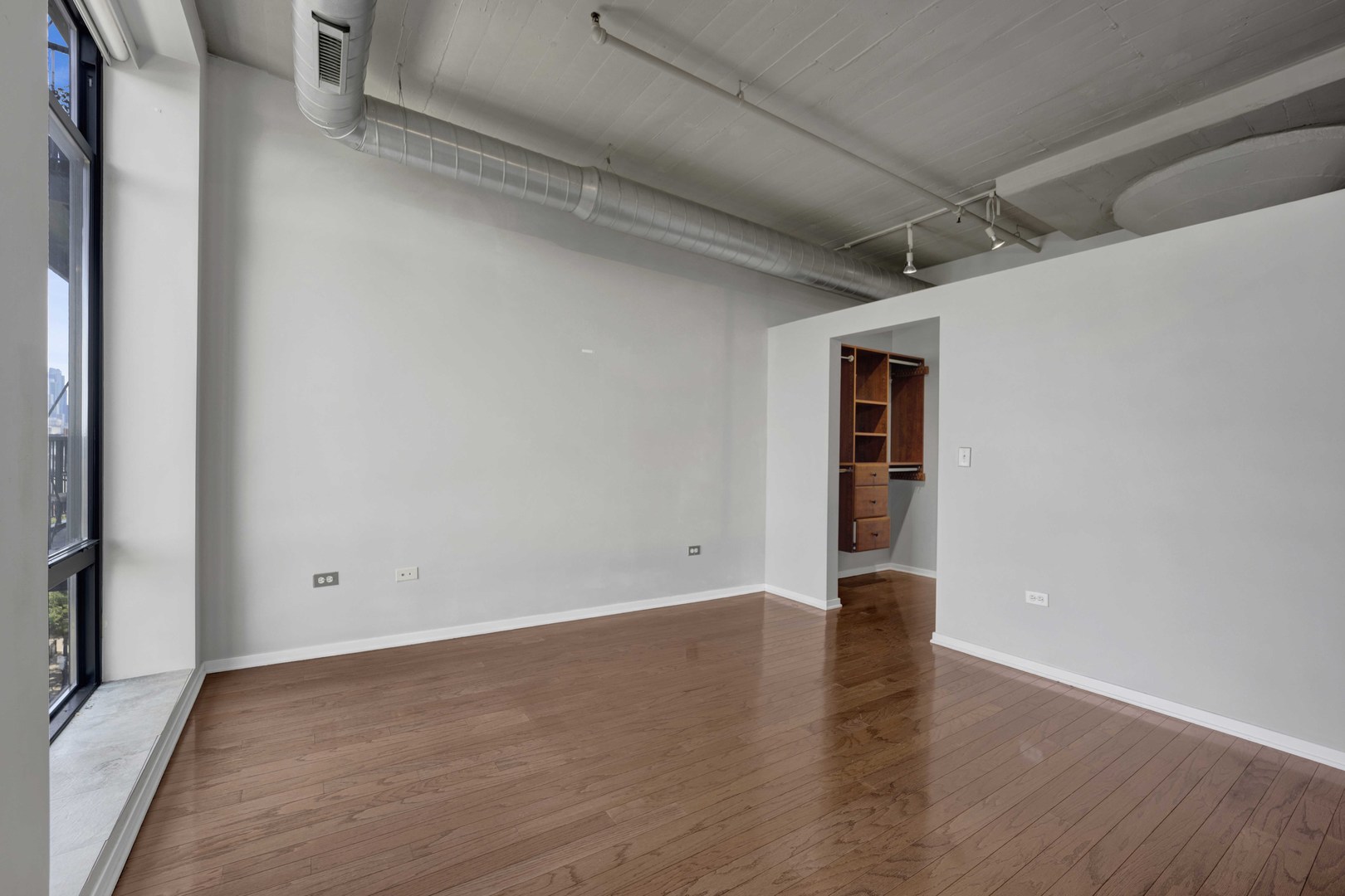 1525 South Sangamon Street, Unit 504 Chicago, IL 60608 - Photo 16 of 32 a view of an empty room with wooden floor