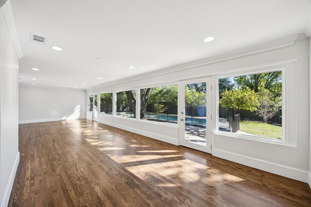 6848 Midcrest Drive Dallas, TX 75254 - Photo 13 of 38 a view of an empty room with wooden floor and a window