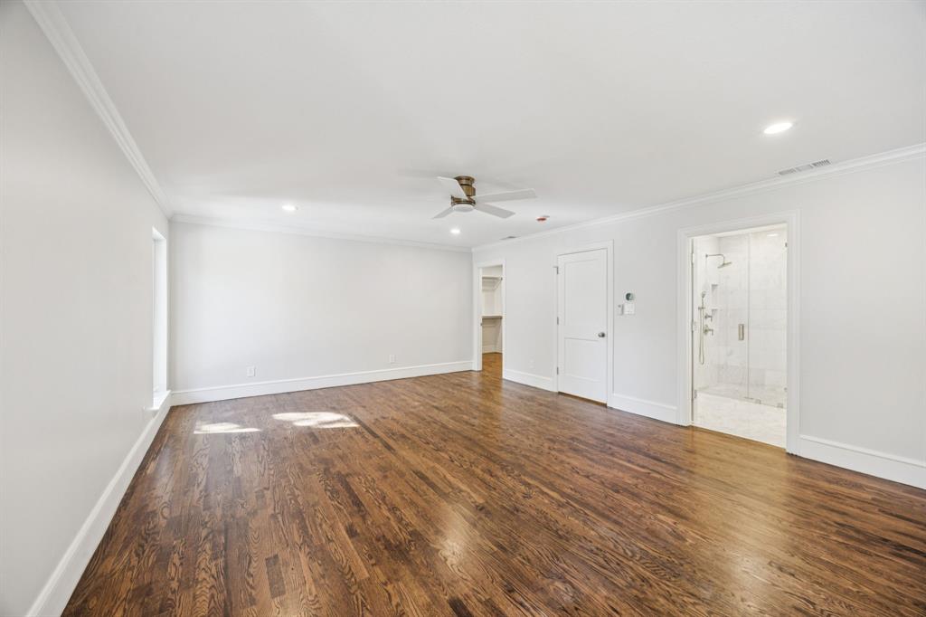 6848 Midcrest Drive Dallas, TX 75254 - Photo 16 of 38 a view of an empty room with wooden floor and a window