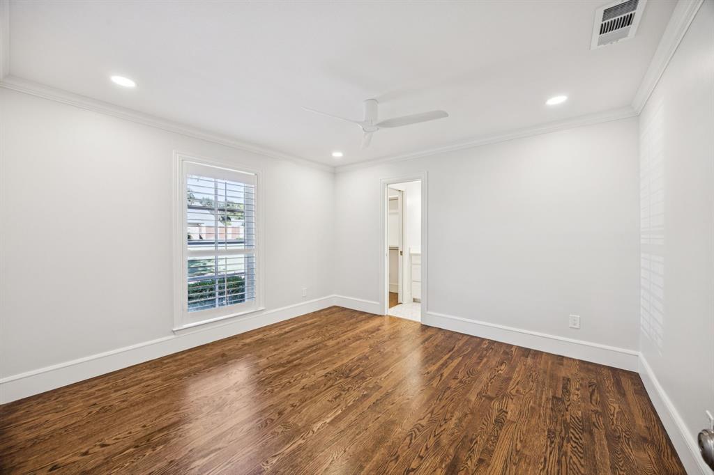 6848 Midcrest Drive Dallas, TX 75254 - Photo 24 of 38 an empty room with wooden floor and windows