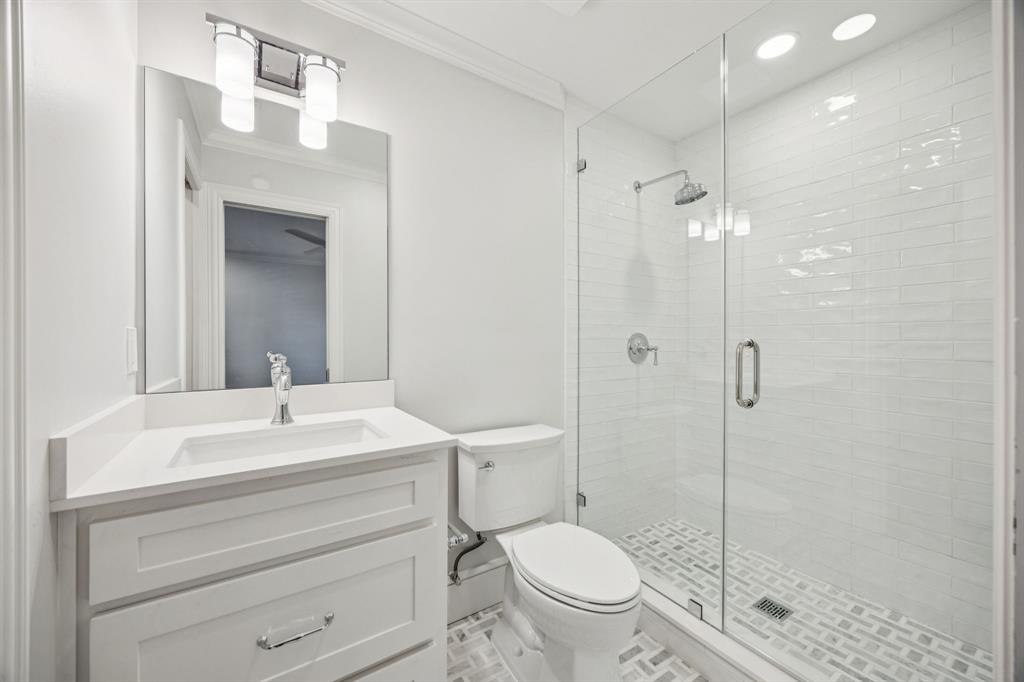 6848 Midcrest Drive Dallas, TX 75254 - Photo 25 of 38 a bathroom with a sink a toilet and shower