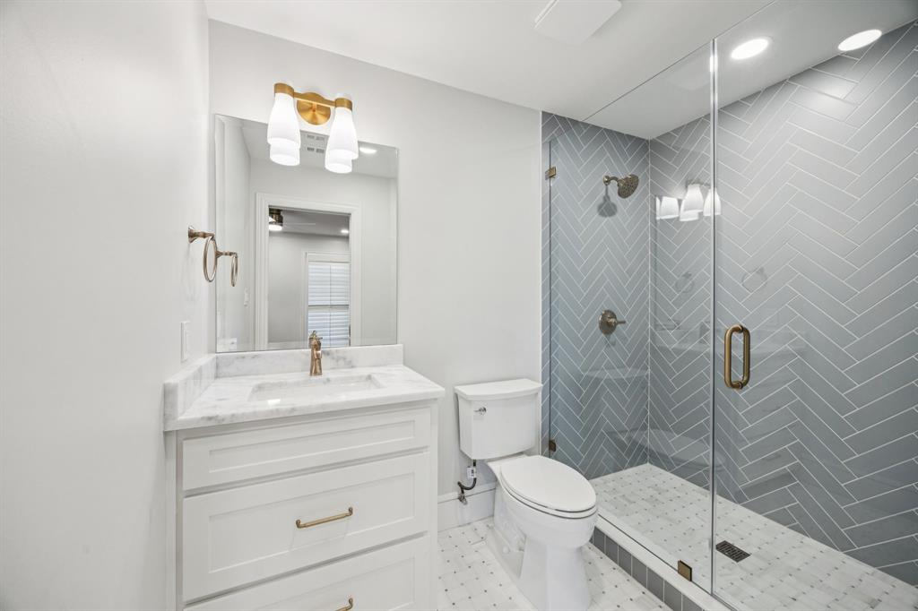 6848 Midcrest Drive Dallas, TX 75254 - Photo 27 of 38 a bathroom with a sink a toilet and shower