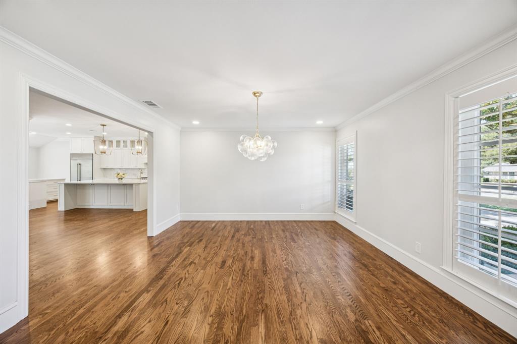 6848 Midcrest Drive Dallas, TX 75254 - Photo 4 of 38 an empty room with wooden floor and windows
