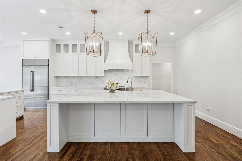 6848 Midcrest Drive Dallas, TX 75254 - Photo 6 of 38 a kitchen with kitchen island granite countertop a sink cabinets and stainless steel appliances