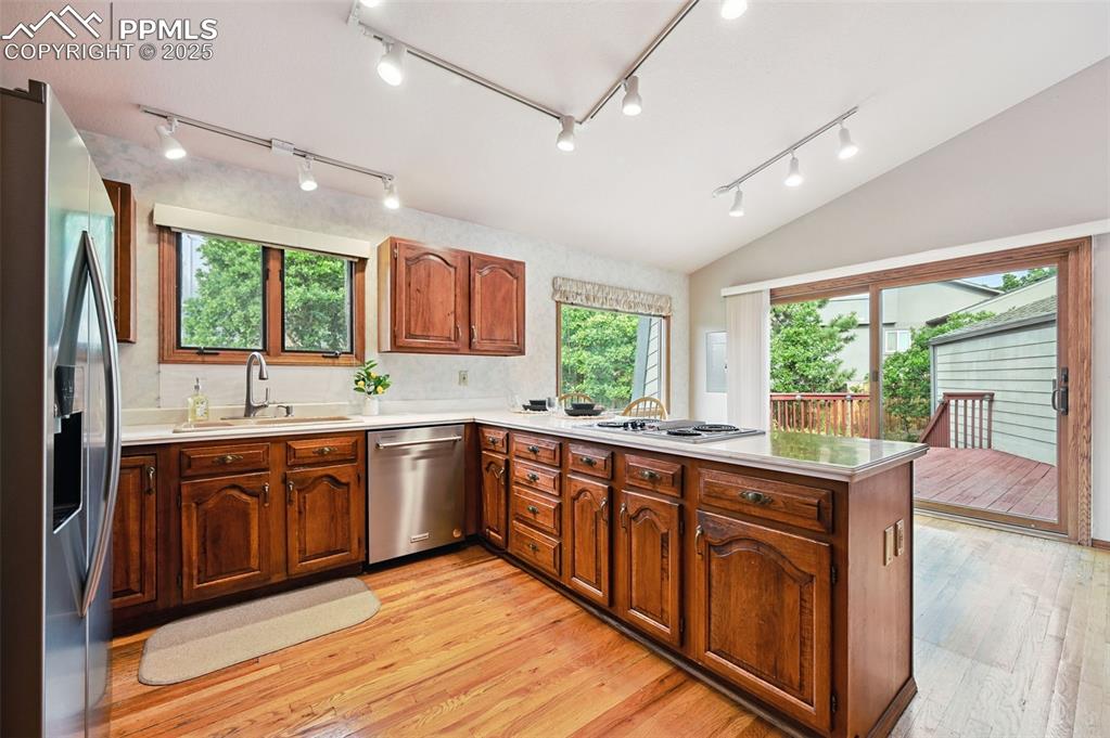 635 Royal Oak Drive Colorado Springs, CO 80906 - Photo 14 of 47 a large kitchen with stainless steel appliances granite countertop sink stove and wooden cabinets