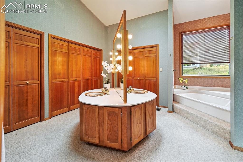 635 Royal Oak Drive Colorado Springs, CO 80906 - Photo 21 of 47 a bathroom with a sink and a mirror