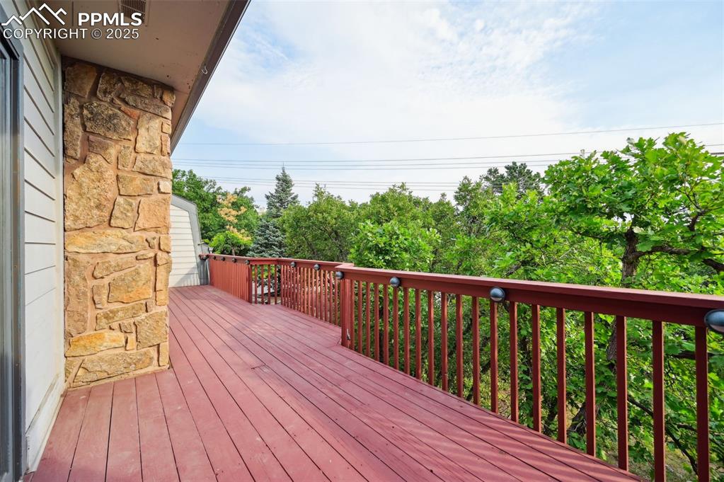 635 Royal Oak Drive Colorado Springs, CO 80906 - Photo 24 of 47 a balcony with wooden floor and city view