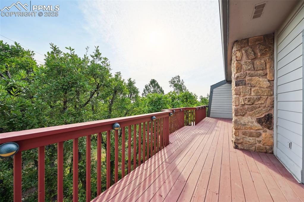 635 Royal Oak Drive Colorado Springs, CO 80906 - Photo 25 of 47 a balcony with wooden floor and outdoor seating
