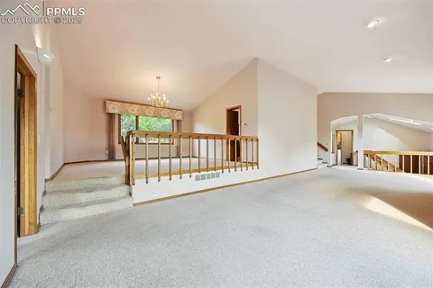 a kitchen with stainless steel appliances granite countertop a sink dishwasher and a refrigerator with wooden cabinets