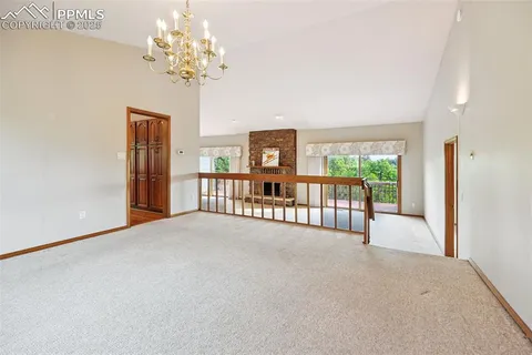 a large kitchen with stainless steel appliances granite countertop sink stove and wooden cabinets