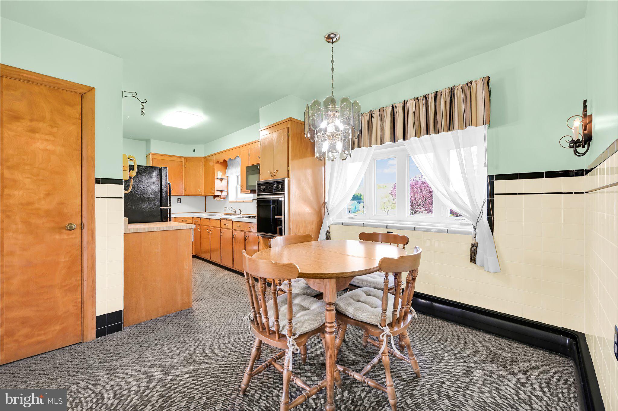 214 West Maple Street Valley View, PA 17983 - Photo 14 of 36 a kitchen with stainless steel appliances kitchen island granite countertop a refrigerator a oven a sink with a dining table and chairs