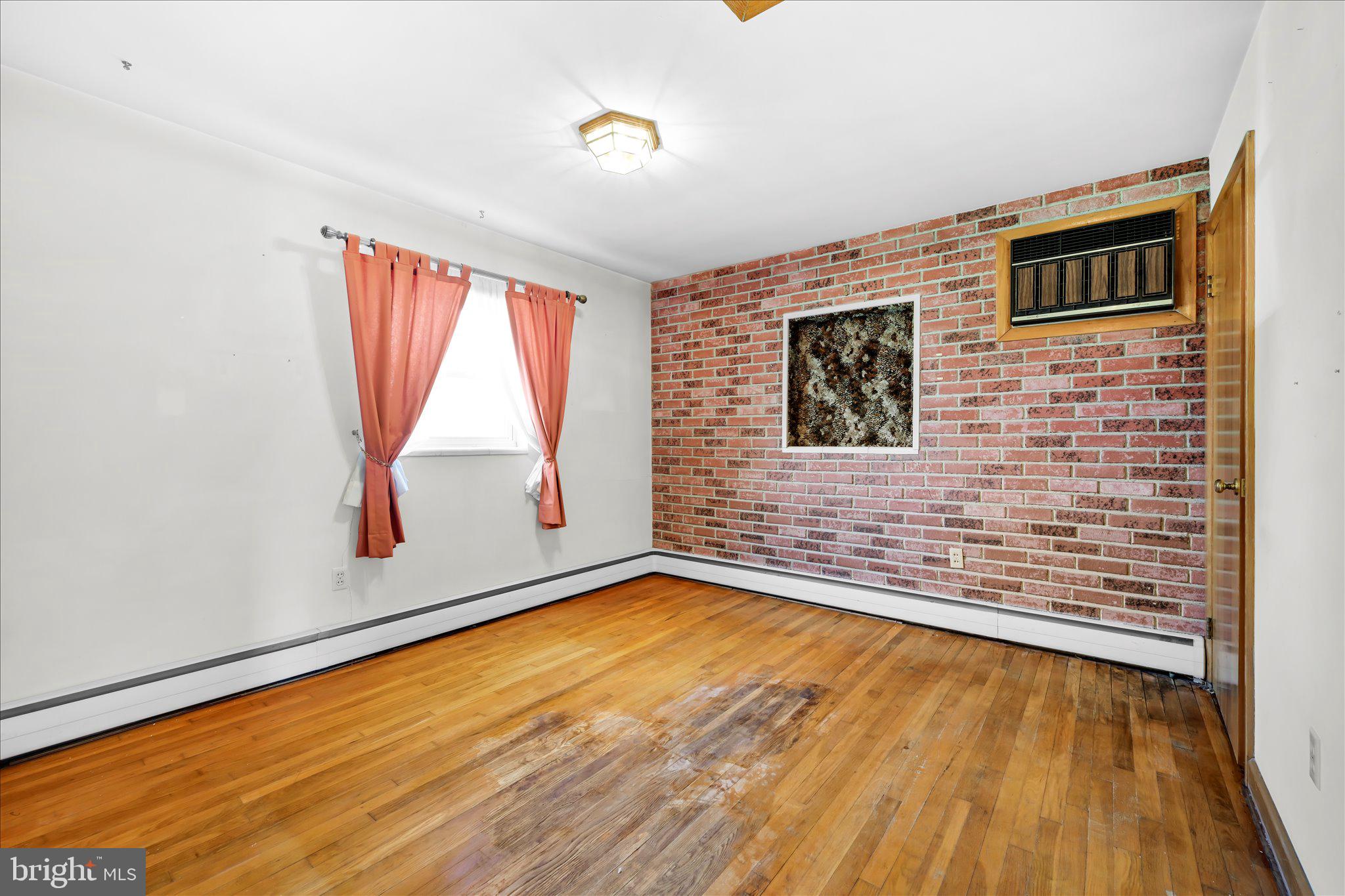 214 West Maple Street Valley View, PA 17983 - Photo 23 of 36 a view of an empty room with a window and wooden floor
