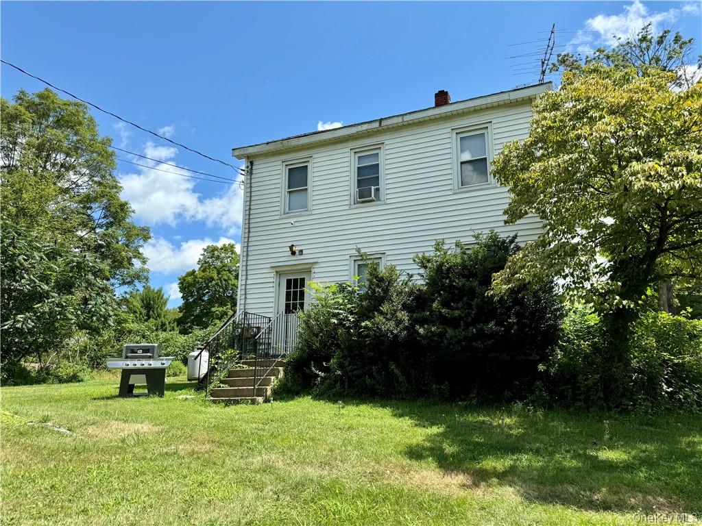 19 Bloomingburg Road Middletown, NY 10940 - Photo 1 of 20 a backyard of a house with table and chairs and potted plants