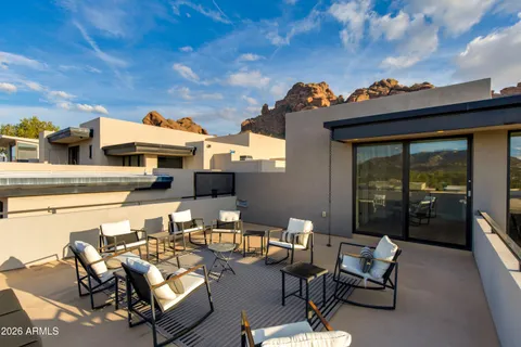 a terrace with outdoor seating and city view