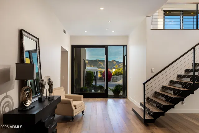 a hallway with wooden floor and furniture