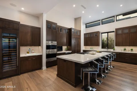 a large kitchen with a table and chairs
