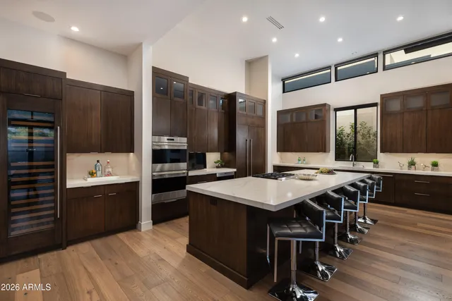 a large kitchen with a table and chairs