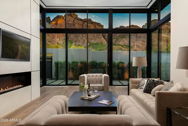 a living room with furniture tv and a fireplace