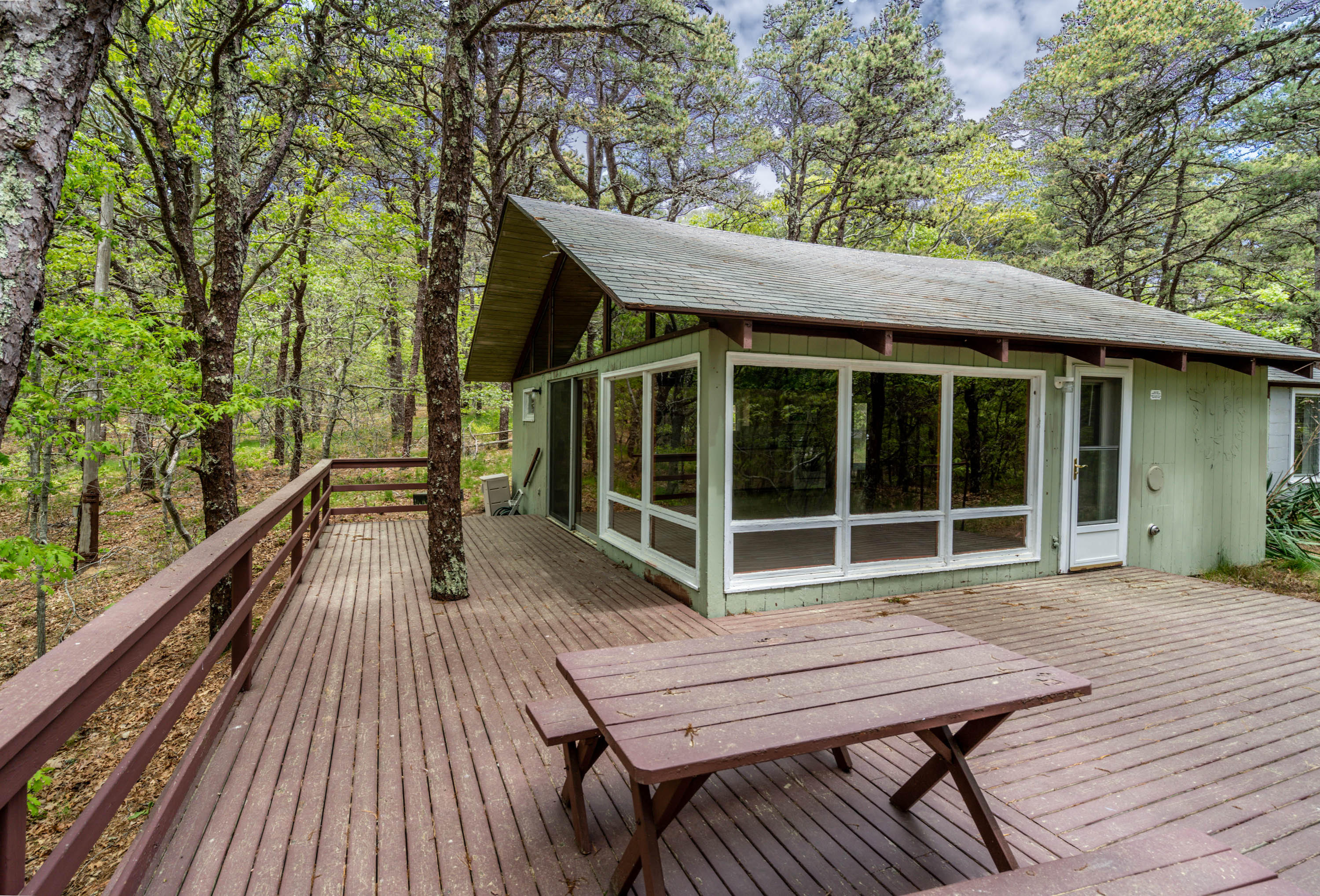 120 Aunt Sally's Road Wellfleet, MA 02667 - Photo 11 of 26 a view of wooden deck with a table and chairs next to a yard