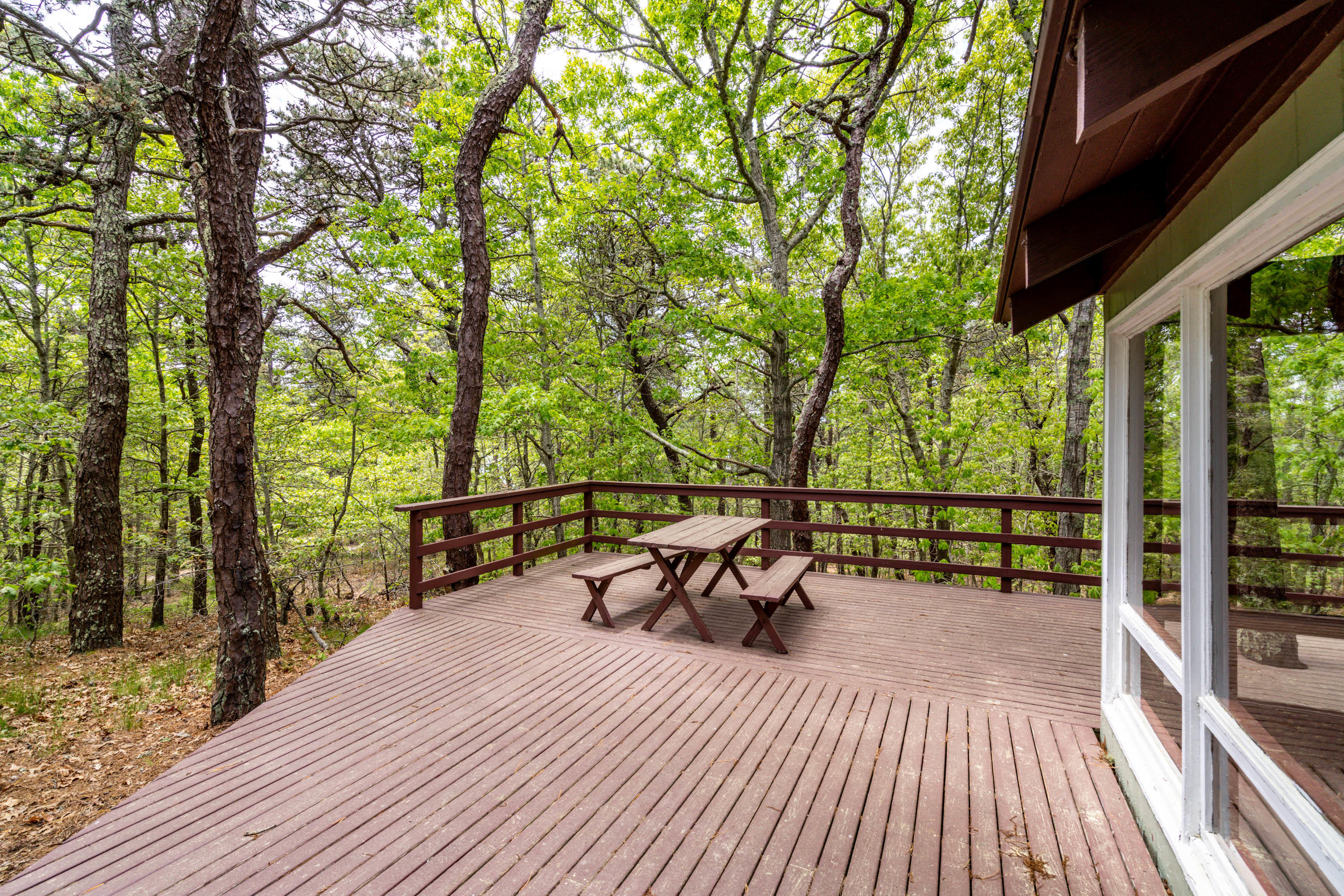 120 Aunt Sally's Road Wellfleet, MA 02667 - Photo 16 of 26 a view of a patio with table and chairs and wooden floor