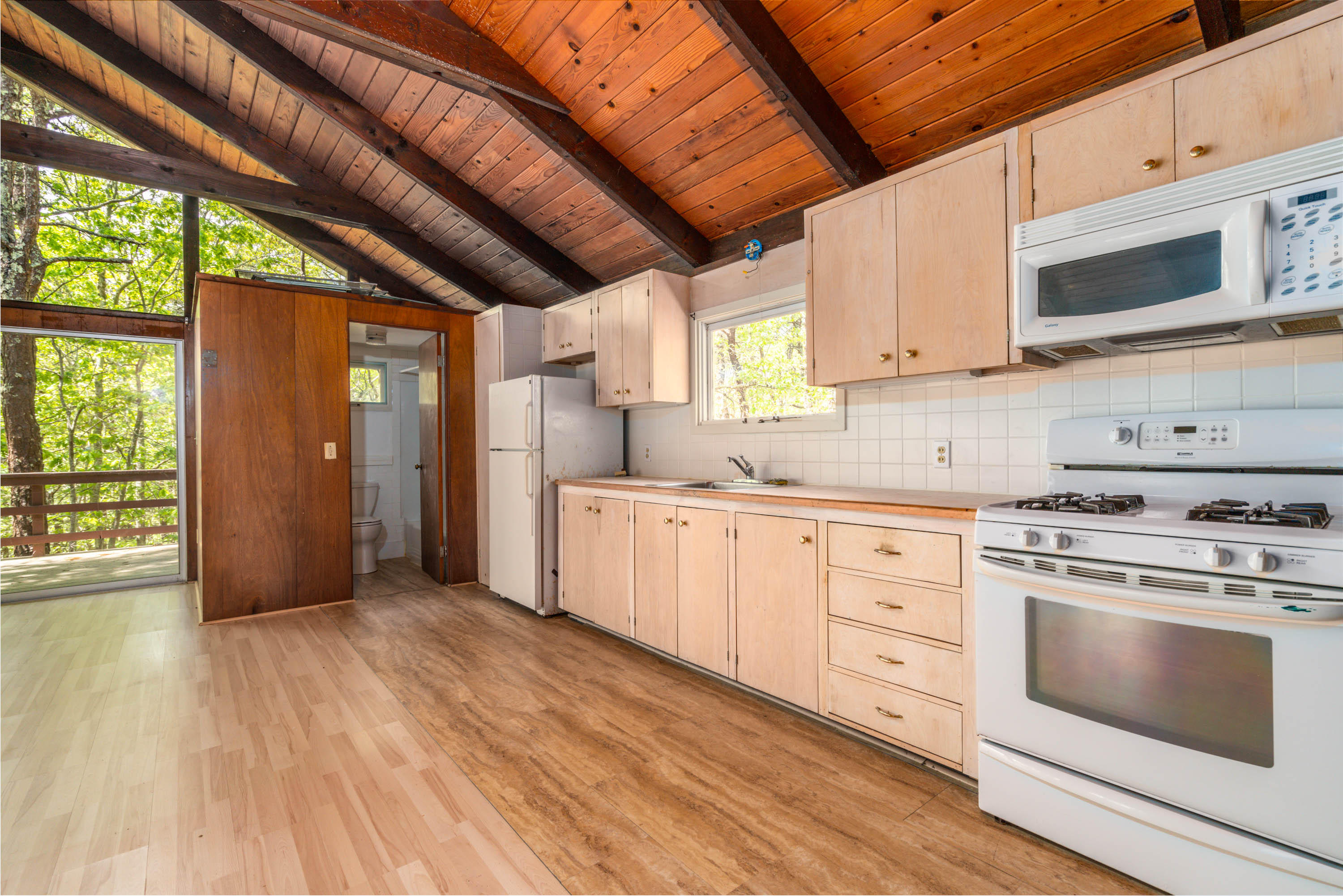120 Aunt Sally's Road Wellfleet, MA 02667 - Photo 20 of 26 a kitchen with stainless steel appliances granite countertop a stove and a microwave