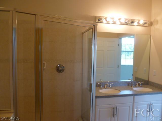 2514 23rd Street Southwest Lehigh Acres, FL 33976 - Photo 14 of 16 a bathroom with a sink and mirror