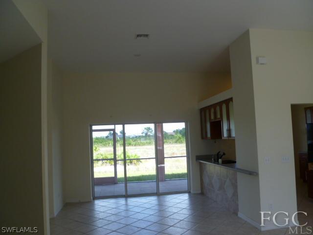 2514 23rd Street Southwest Lehigh Acres, FL 33976 - Photo 2 of 16 a view of empty room with wooden floor and fan