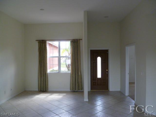 2514 23rd Street Southwest Lehigh Acres, FL 33976 - Photo 4 of 16 an empty room that has a mirror in it