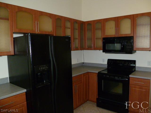 2514 23rd Street Southwest Lehigh Acres, FL 33976 - Photo 6 of 16 a kitchen with a refrigerator stove and microwave