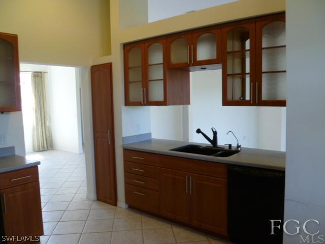 2514 23rd Street Southwest Lehigh Acres, FL 33976 - Photo 7 of 16 a kitchen with a sink and a mirror