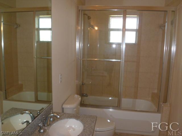 2514 23rd Street Southwest Lehigh Acres, FL 33976 - Photo 10 of 16 a bathroom with a granite countertop sink toilet and shower