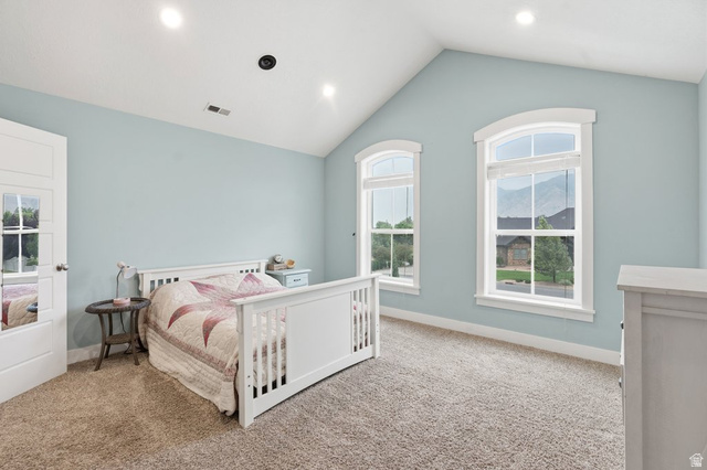 672 Perry Hollow Drive Mapleton, UT 84664 - Photo 55 of 106 Room featuring a vaulted ceiling with recessed lighting, two arched windows with mountain scenery, and light blue walls