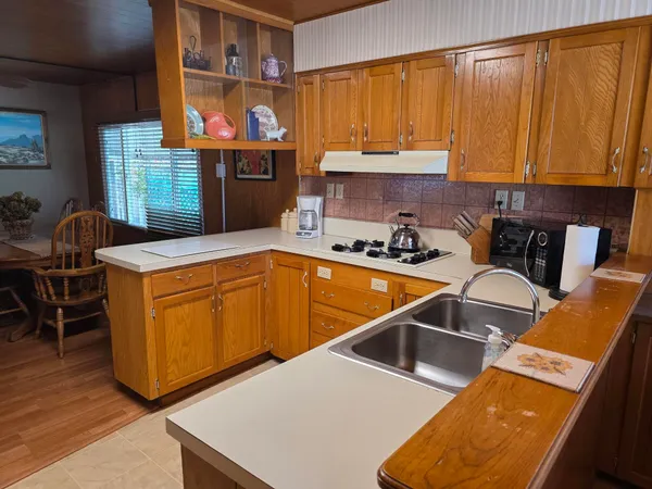 a kitchen with a sink a counter space and a window