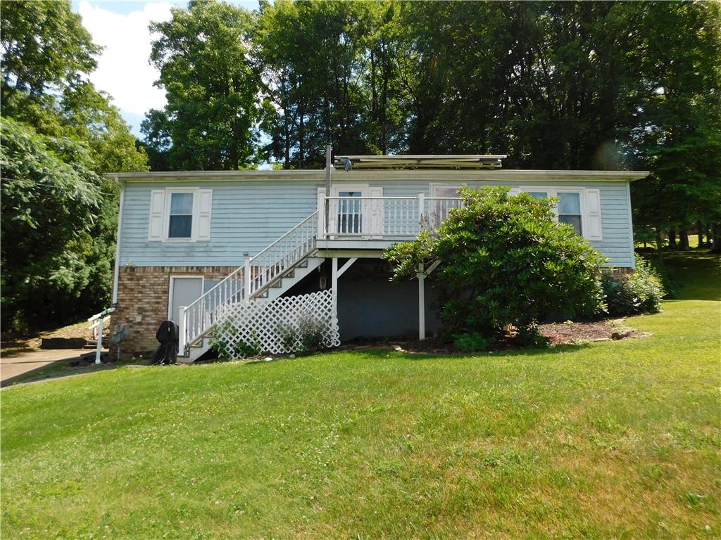 612 Upper Middletown Road Smock, PA 15480 - Photo 1 of 17 a view of a house with a yard and sitting area