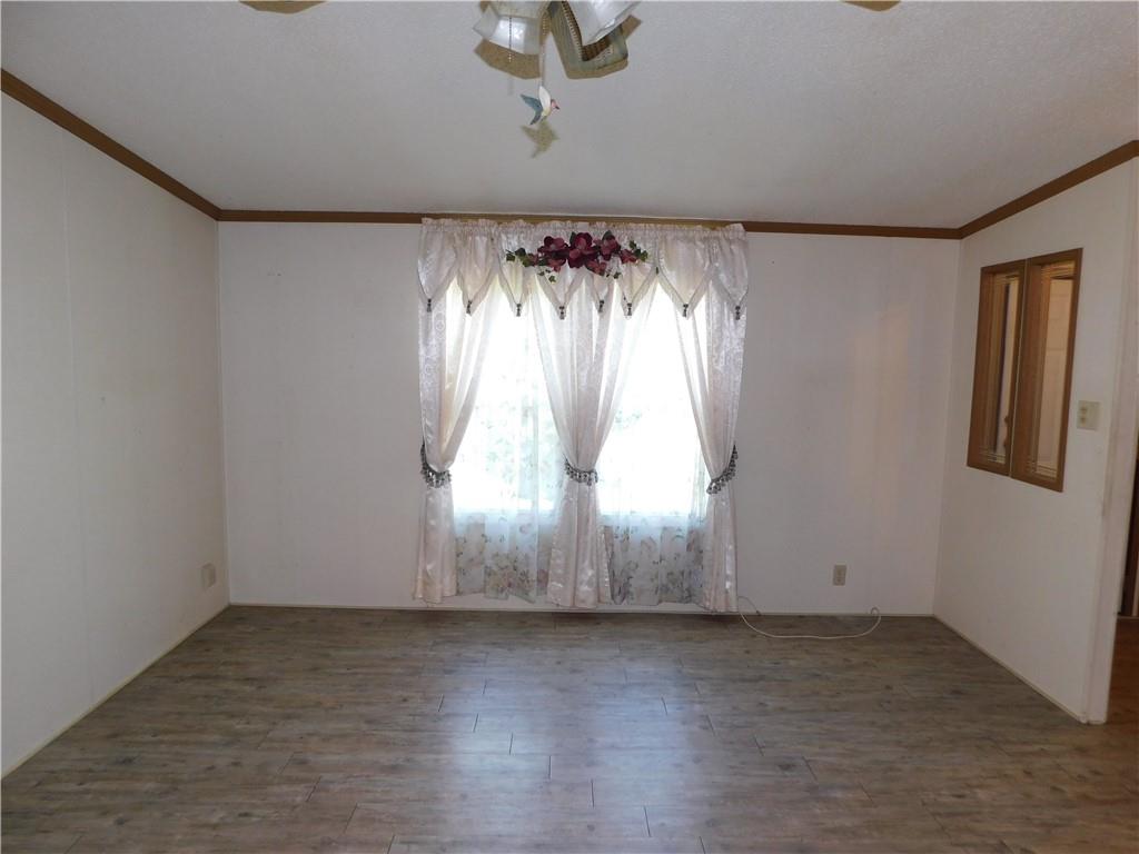 612 Upper Middletown Road Smock, PA 15480 - Photo 11 of 17 an empty room with wooden floor and windows