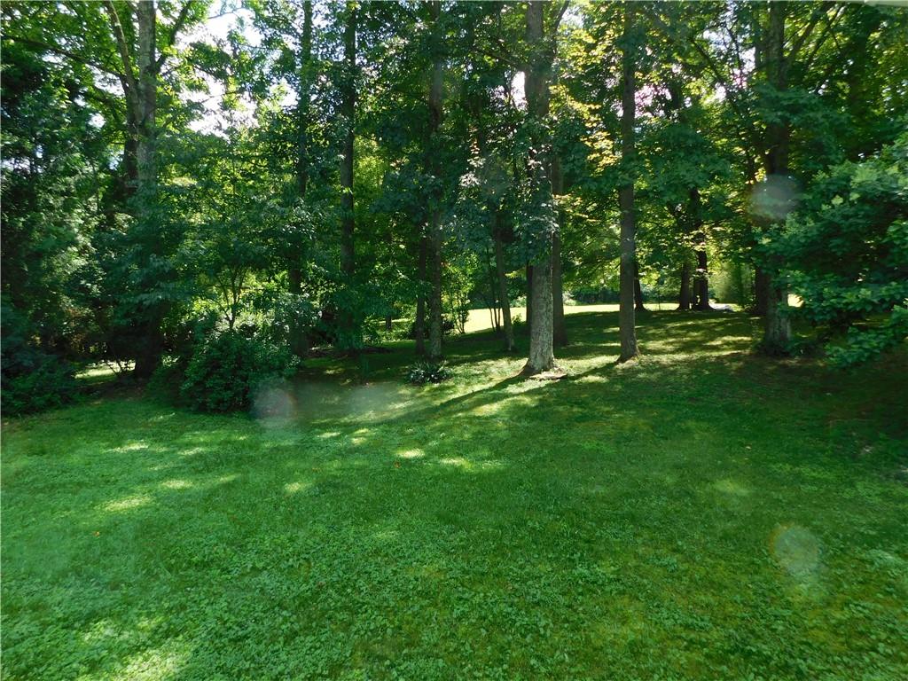 612 Upper Middletown Road Smock, PA 15480 - Photo 3 of 17 a green field with lots of trees