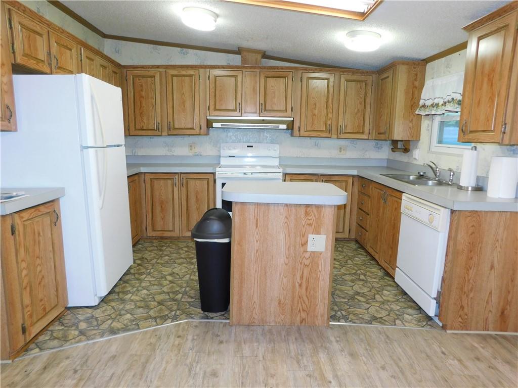 612 Upper Middletown Road Smock, PA 15480 - Photo 8 of 17 a kitchen with stainless steel appliances granite countertop a refrigerator sink and cabinets