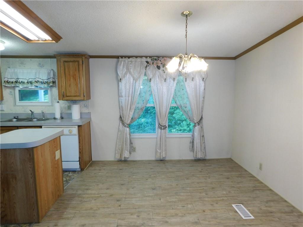 612 Upper Middletown Road Smock, PA 15480 - Photo 10 of 17 a view of a kitchen with a sink and dishwasher with wooden floor