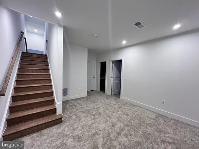 a bathroom with a sink a light fixture and a mirror