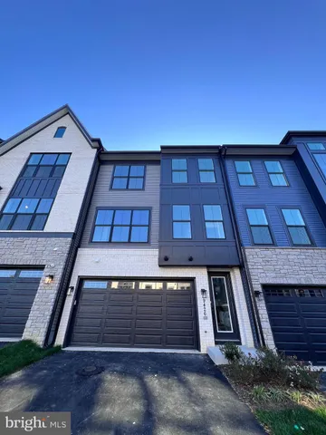 a large kitchen with stainless steel appliances granite countertop a stove and a refrigerator