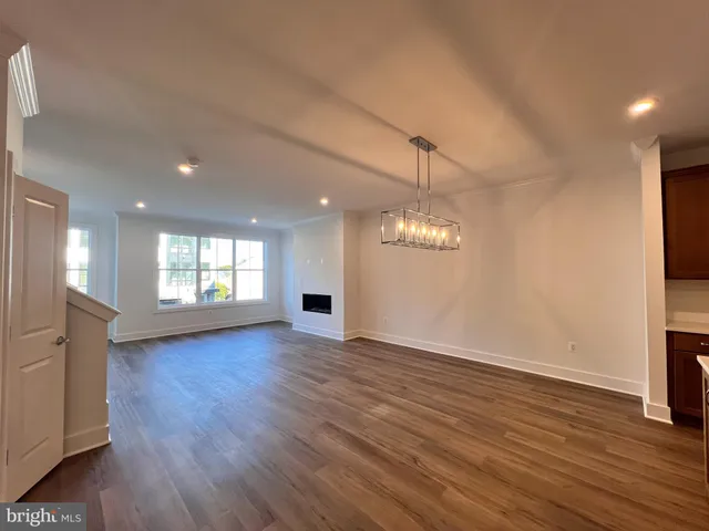 a large kitchen with stainless steel appliances granite countertop a lot of cabinets and wooden floor