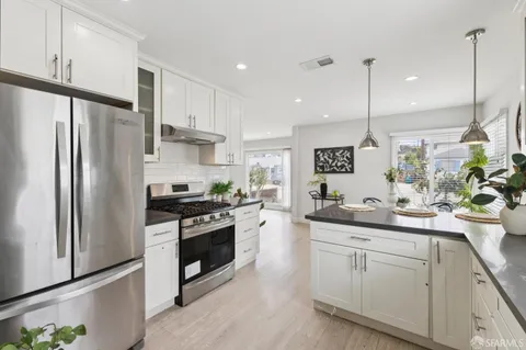 a kitchen with a sink stainless steel appliances and counter space