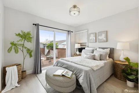 a bedroom with a bed and a potted plant