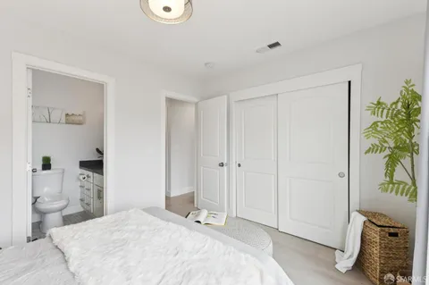 a bedroom with a bed and a potted plant